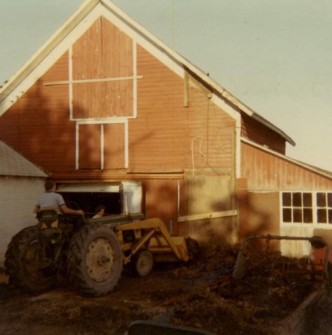Jim Searles 1969 cleaning up old silage from torn down silo